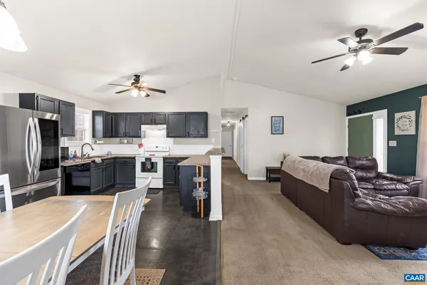 a kitchen with a stove refrigerator and microwave