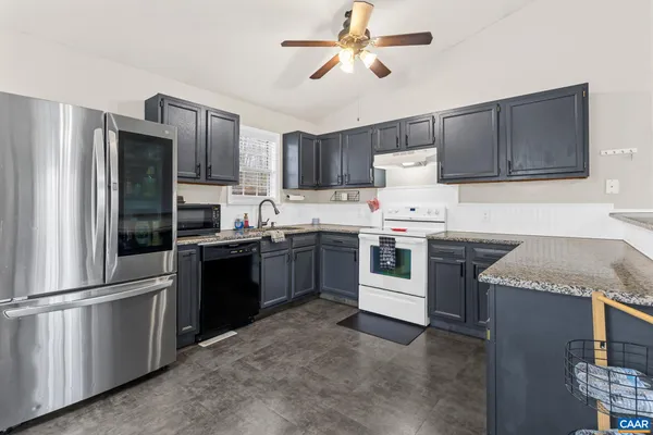 a kitchen with a stove cabinets and window