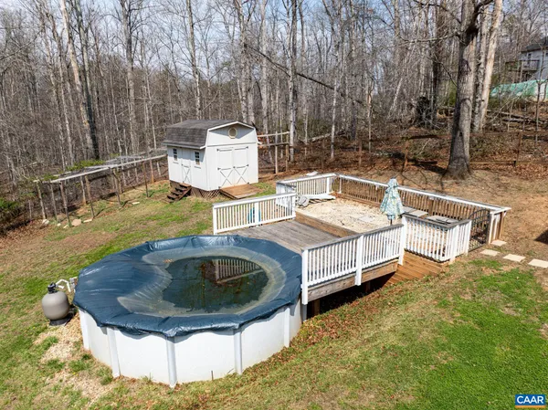 a view of backyard with deck and outdoor seating