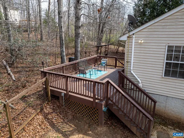 a view of balcony with wooden floor and fence