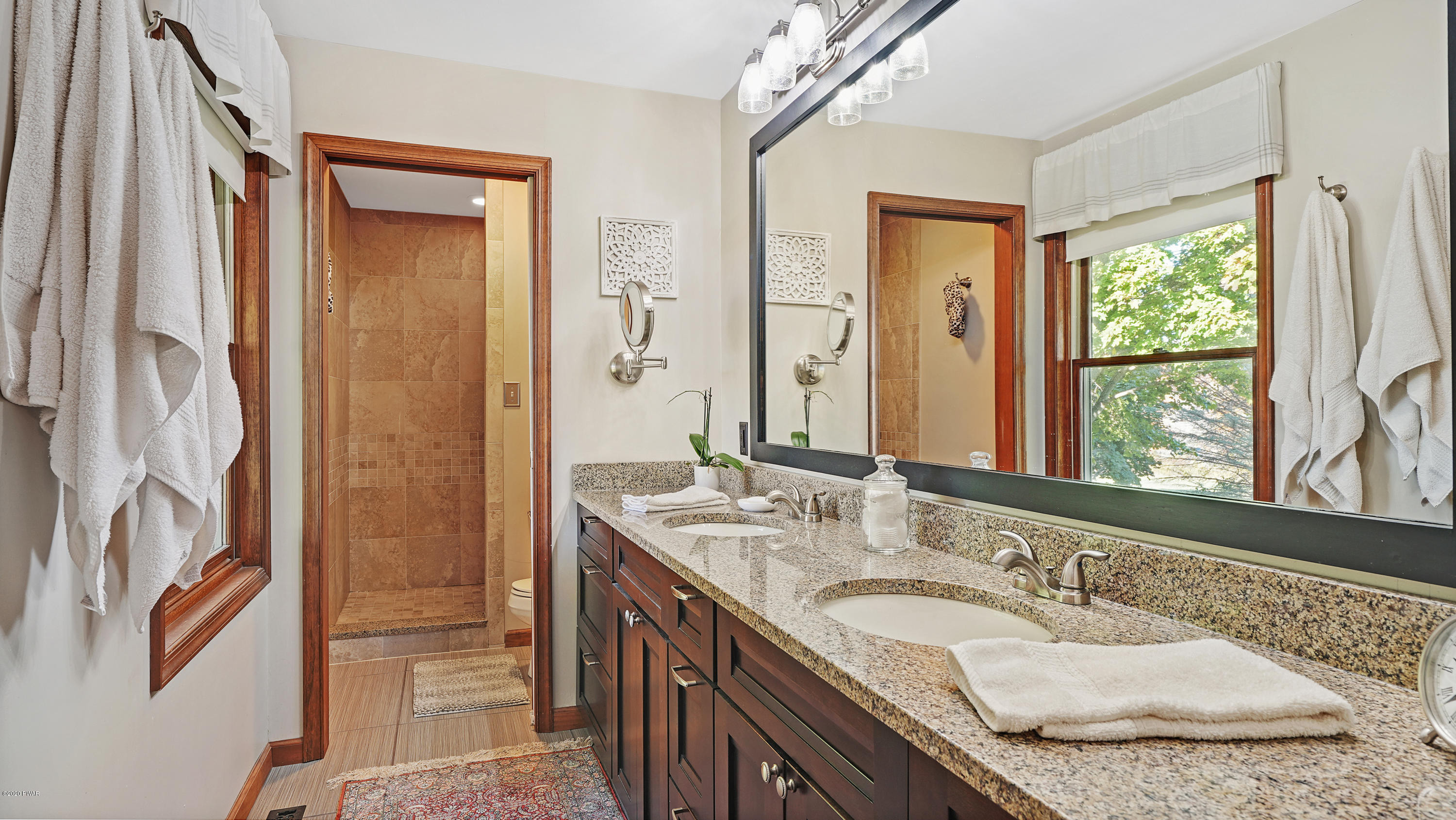 161 J J Road Moscow, PA 18444 - Photo 49 of 73 a bathroom with a granite countertop double vanity sink a mirror and a shower