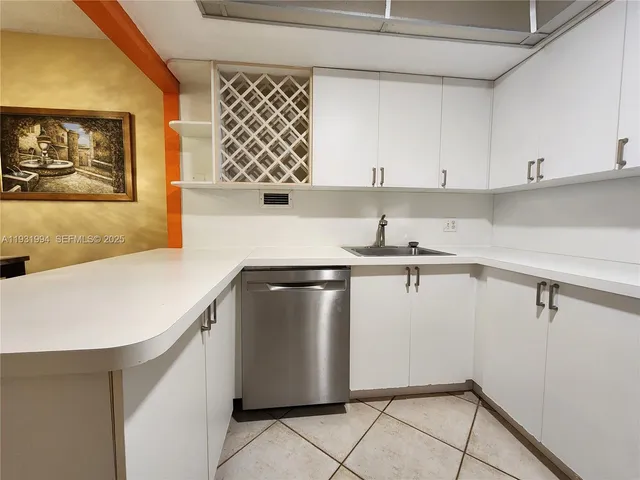 a kitchen with a sink and cabinets