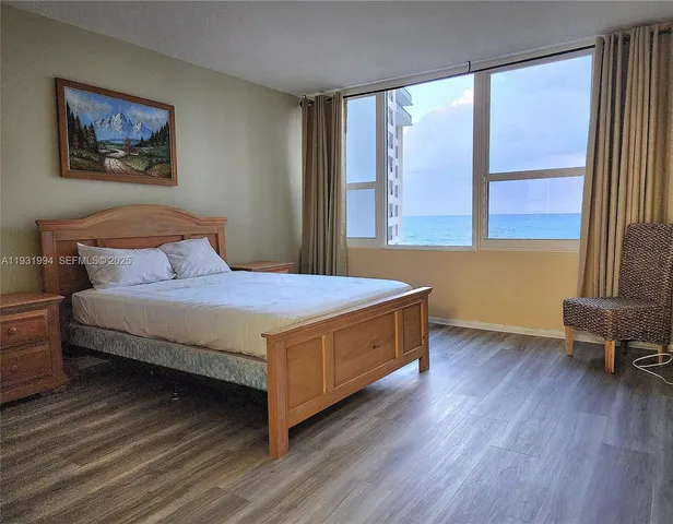 a bedroom with a bed and a large window