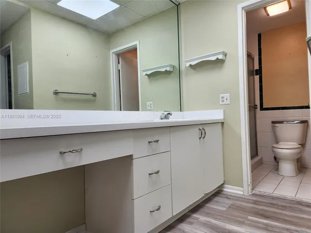 a bathroom with a sink a toilet and mirror