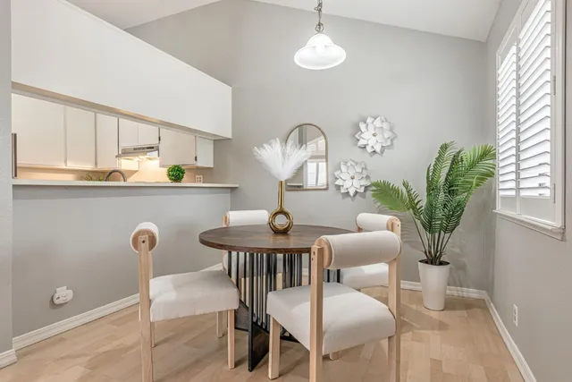 a view of a dining room with furniture and a chandelier