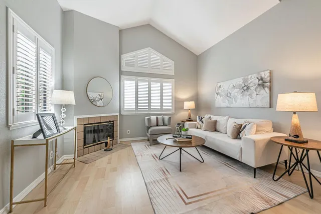 a living room with furniture a fireplace and a window