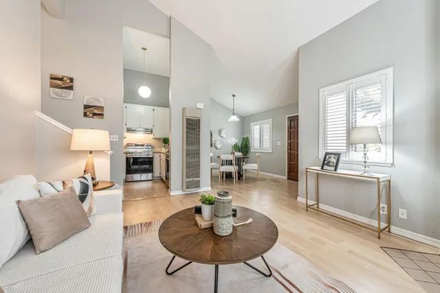 a living room with fireplace furniture and a wooden floor