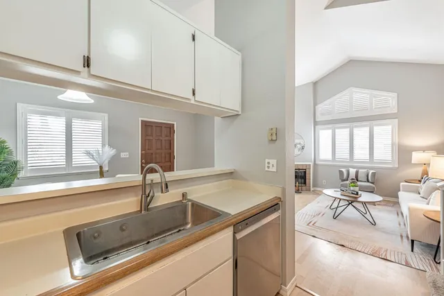 a kitchen with stainless steel appliances granite countertop a sink and a refrigerator
