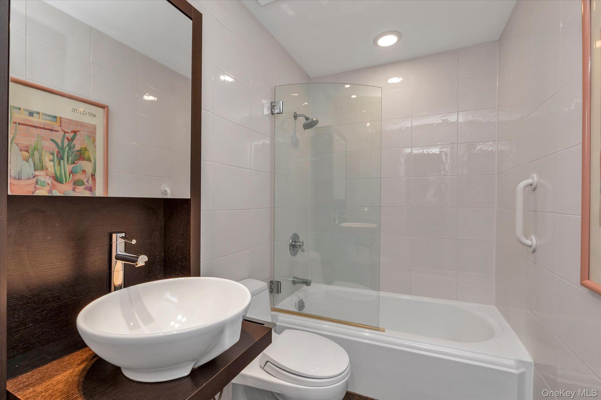 41 Spring Hollow Road Roslyn, NY 11576 - Photo 16 of 27 a bathroom with a toilet a sink and bathtub