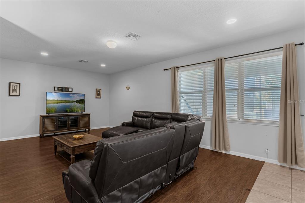 1641 Regal River Circle Ocoee, FL 34761 - Photo 15 of 42 a living room with furniture and a flat screen tv