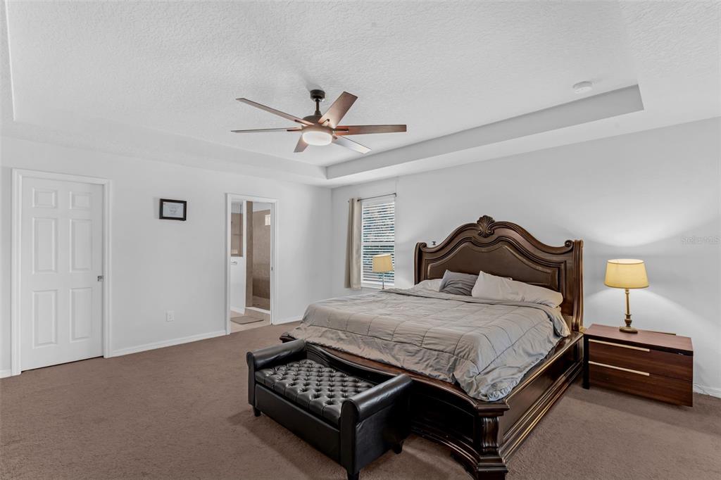 1641 Regal River Circle Ocoee, FL 34761 - Photo 23 of 42 a bedroom with a bed and a chandelier