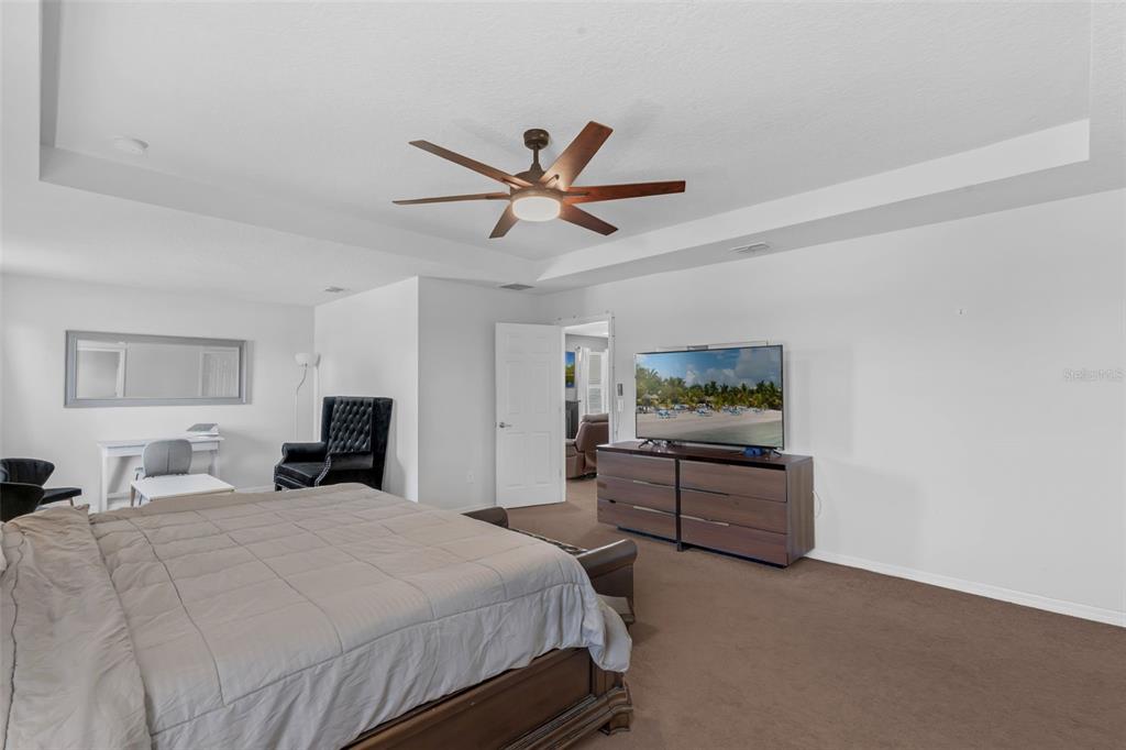 1641 Regal River Circle Ocoee, FL 34761 - Photo 26 of 42 a bedroom with a bed and dresser