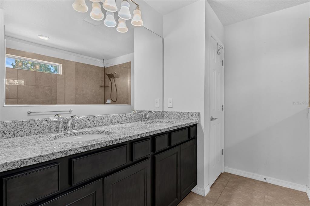 1641 Regal River Circle Ocoee, FL 34761 - Photo 29 of 42 a bathroom with a granite countertop sink and a mirror