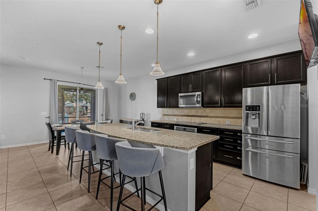 1641 Regal River Circle Ocoee, FL 34761 - Photo 3 of 42 a kitchen with a center island and chairs