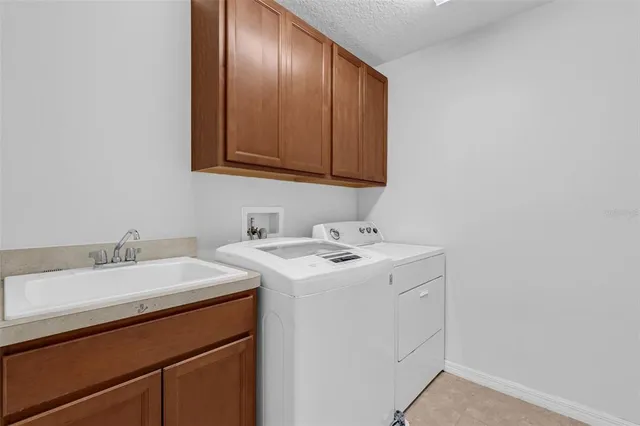a bathroom with a granite countertop toilet sink and mirror
