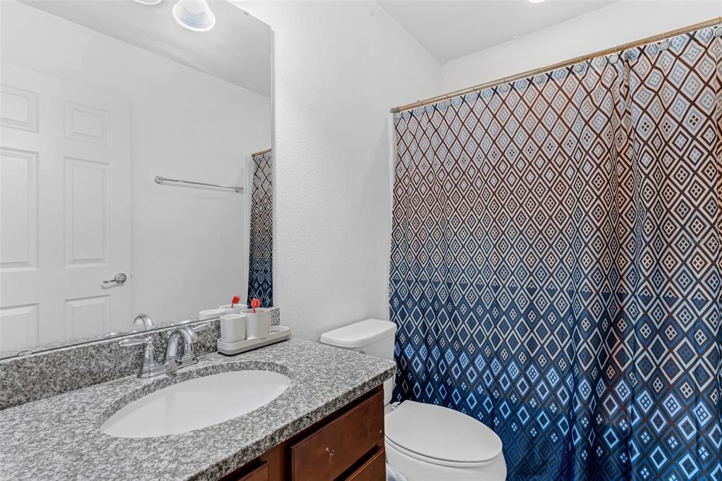 1641 Regal River Circle Ocoee, FL 34761 - Photo 32 of 42 a bathroom with a granite countertop toilet sink and mirror