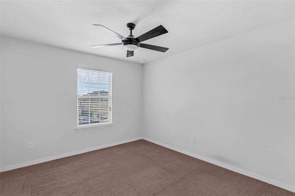 1641 Regal River Circle Ocoee, FL 34761 - Photo 38 of 42 an empty room with windows and fan