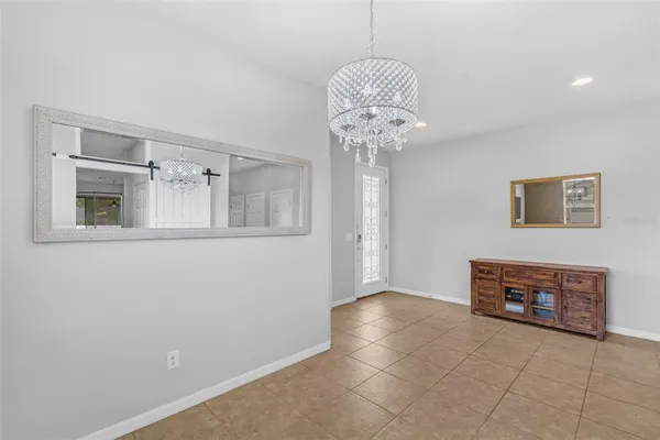 a view of a livingroom with a chandelier fan and furniture