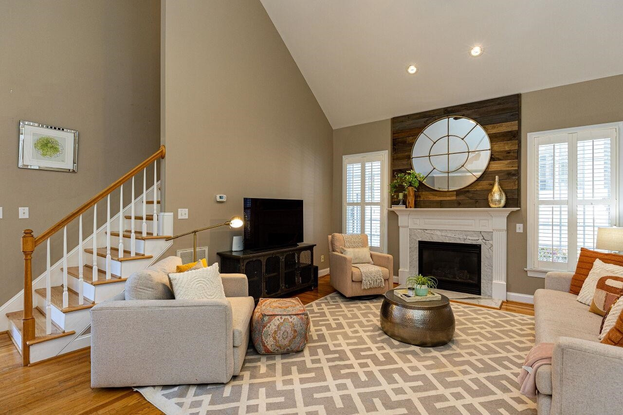 117 Kingsport Road Holly Springs, NC 27540 - Photo 8 of 41 Reclaimed wood fireplace wall with pivot lighting is a show stopper! Large space is the heart of the home! Family Room