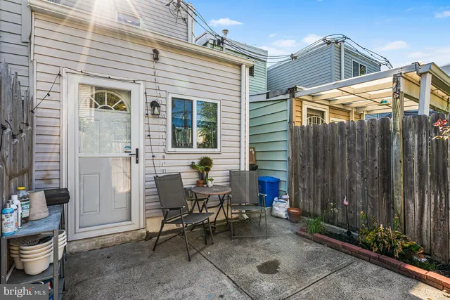 a view of a patio with table and chairs and potted plants
