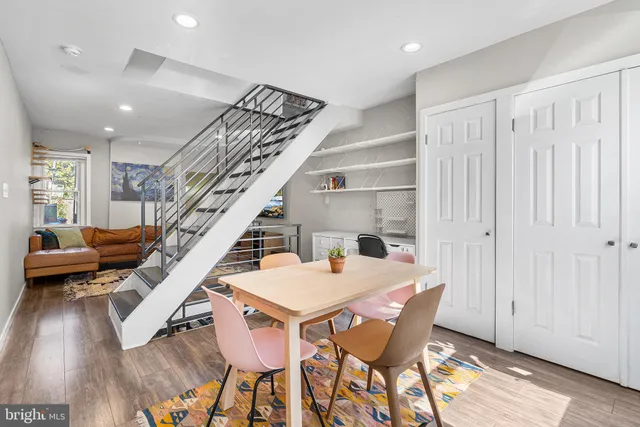 a dining room with furniture and wooden floor