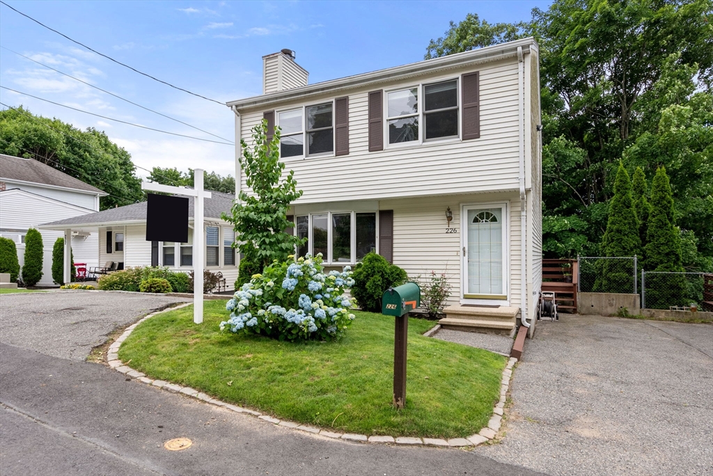 226 Pine Hill Circle Waltham, MA 02451 - Photo 1 of 28 a front view of house with a garden