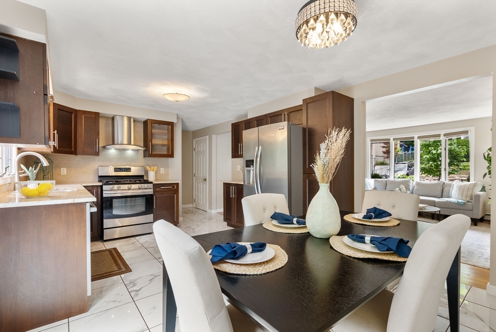 226 Pine Hill Circle Waltham, MA 02451 - Photo 11 of 28 a kitchen with a table stainless steel appliances and cabinets