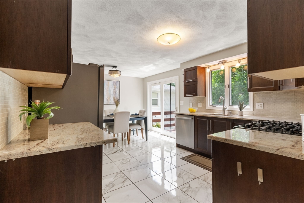 226 Pine Hill Circle Waltham, MA 02451 - Photo 12 of 28 a kitchen with granite countertop a sink and a stove top oven