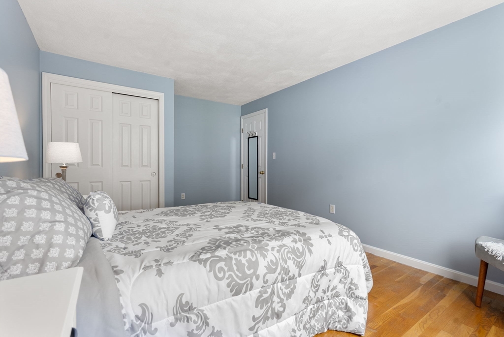 226 Pine Hill Circle Waltham, MA 02451 - Photo 17 of 28 a bedroom with a bed and wooden floor