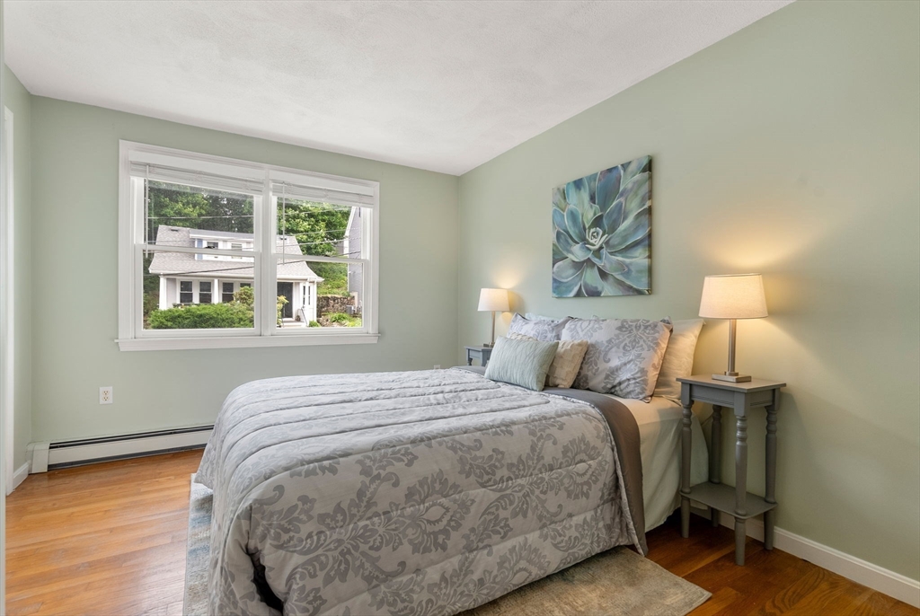 226 Pine Hill Circle Waltham, MA 02451 - Photo 18 of 28 a bedroom with a bed and a painting on the wall