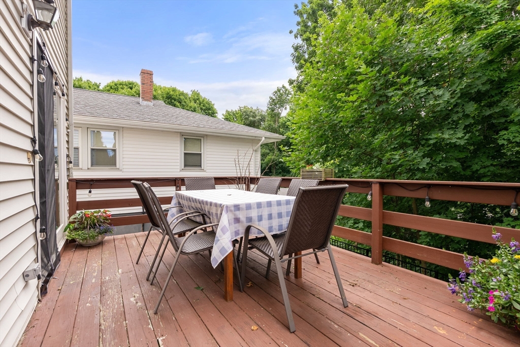 226 Pine Hill Circle Waltham, MA 02451 - Photo 23 of 28 a roof deck with table and chairs and wooden floor