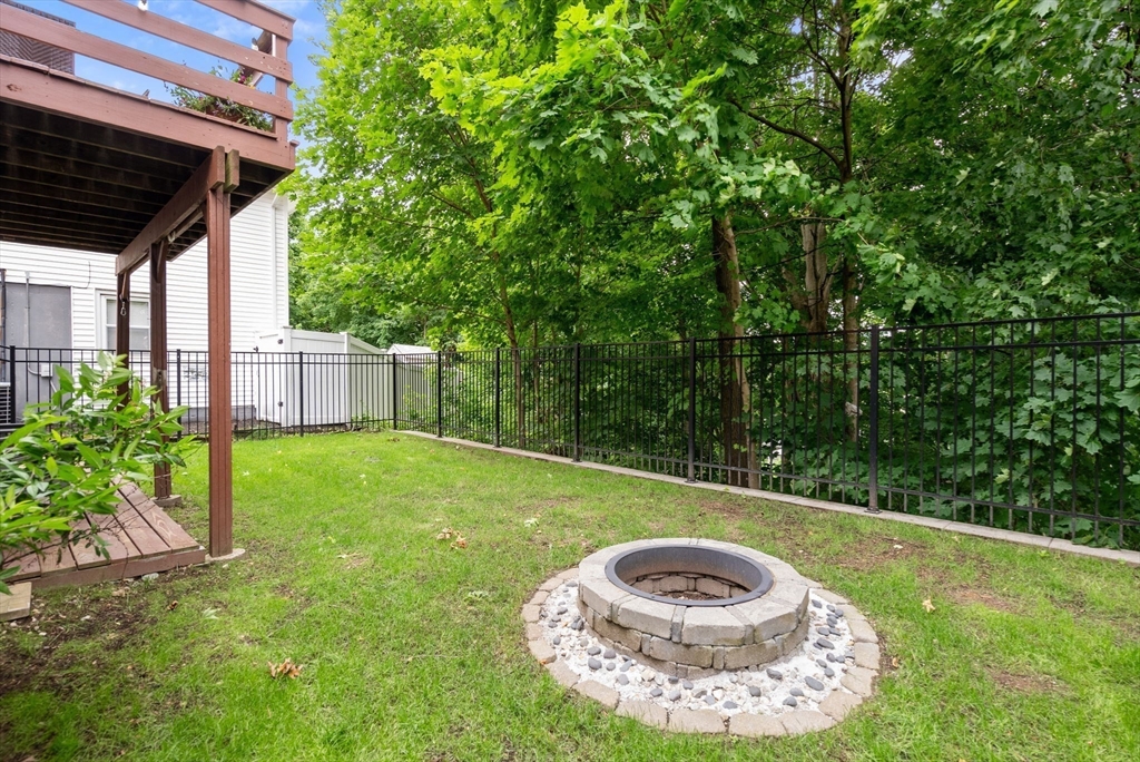 226 Pine Hill Circle Waltham, MA 02451 - Photo 26 of 28 a view of a backyard with plants and a fountain
