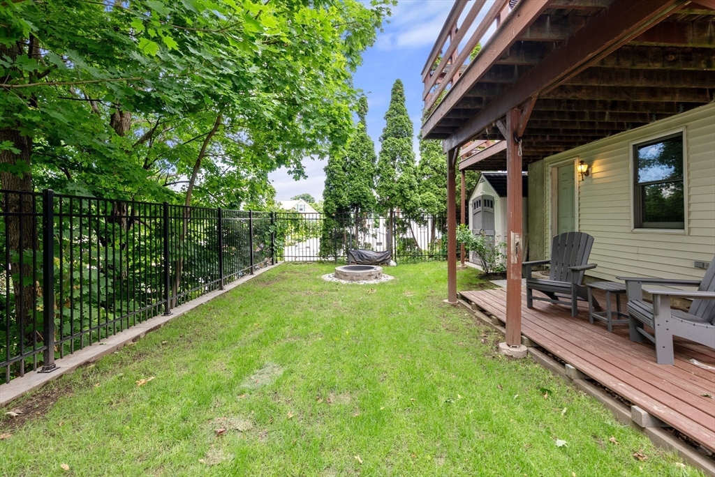 226 Pine Hill Circle Waltham, MA 02451 - Photo 28 of 28 a view of a backyard with couches chair and wooden fence