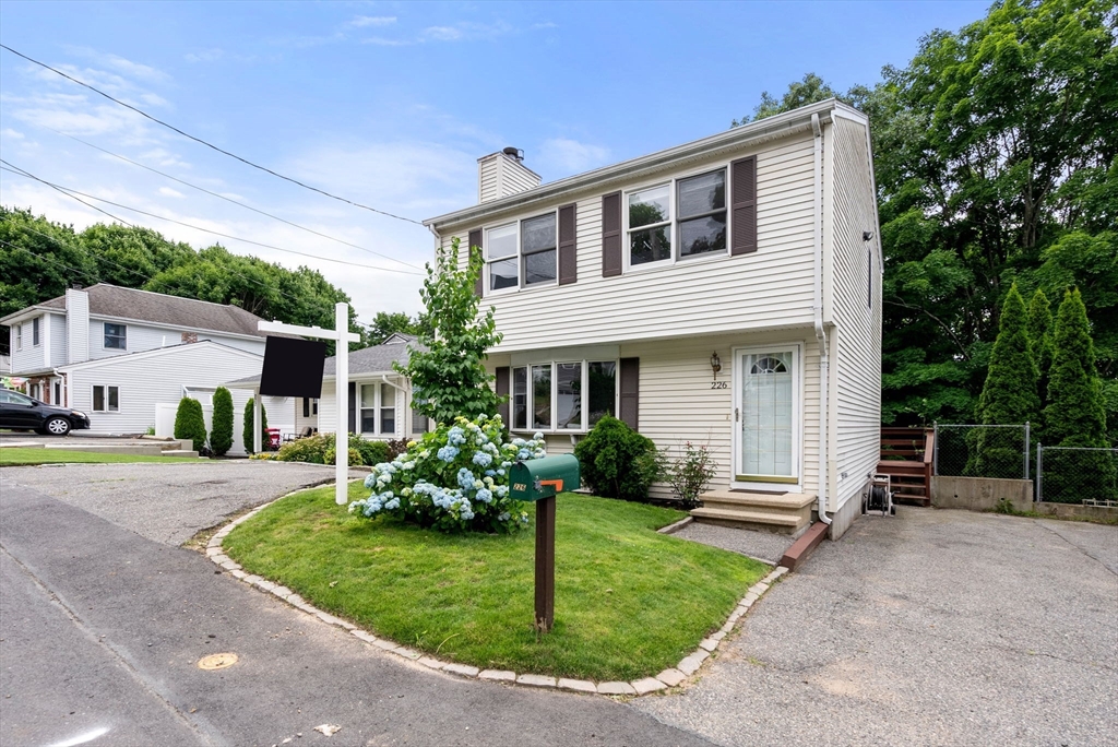 226 Pine Hill Circle Waltham, MA 02451 - Photo 3 of 28 a front view of a house with garden