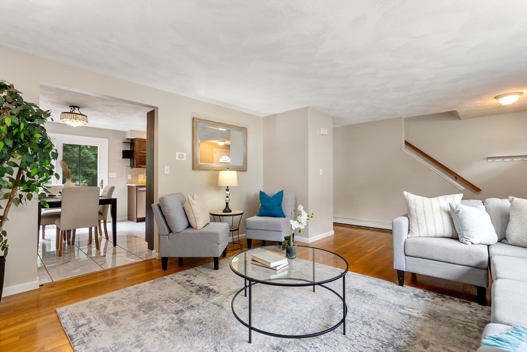 226 Pine Hill Circle Waltham, MA 02451 - Photo 6 of 28 a living room with furniture a rug and a dining table with wooden floor