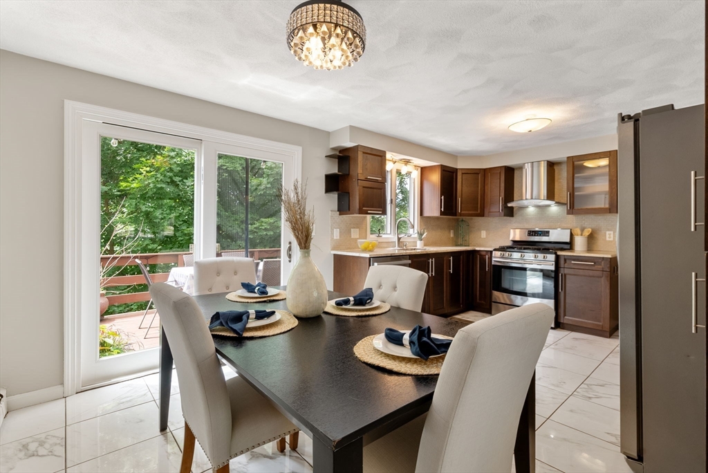 226 Pine Hill Circle Waltham, MA 02451 - Photo 10 of 28 a kitchen with a refrigerator a stove a dining table and chairs