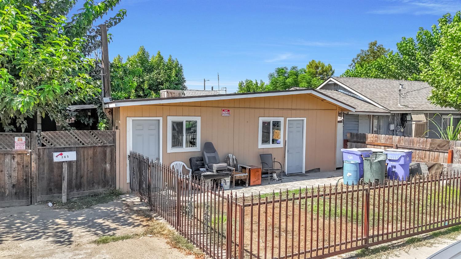 255 J Street Parlier, CA 93648 - Photo 14 of 19 a view of a house with a small yard and wooden fence