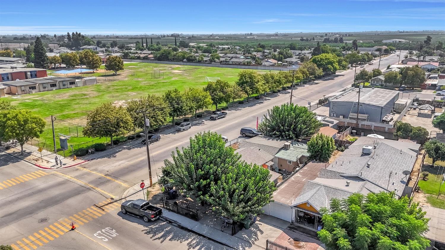 255 J Street Parlier, CA 93648 - Photo 2 of 19 an aerial view of residential houses with outdoor space and street view