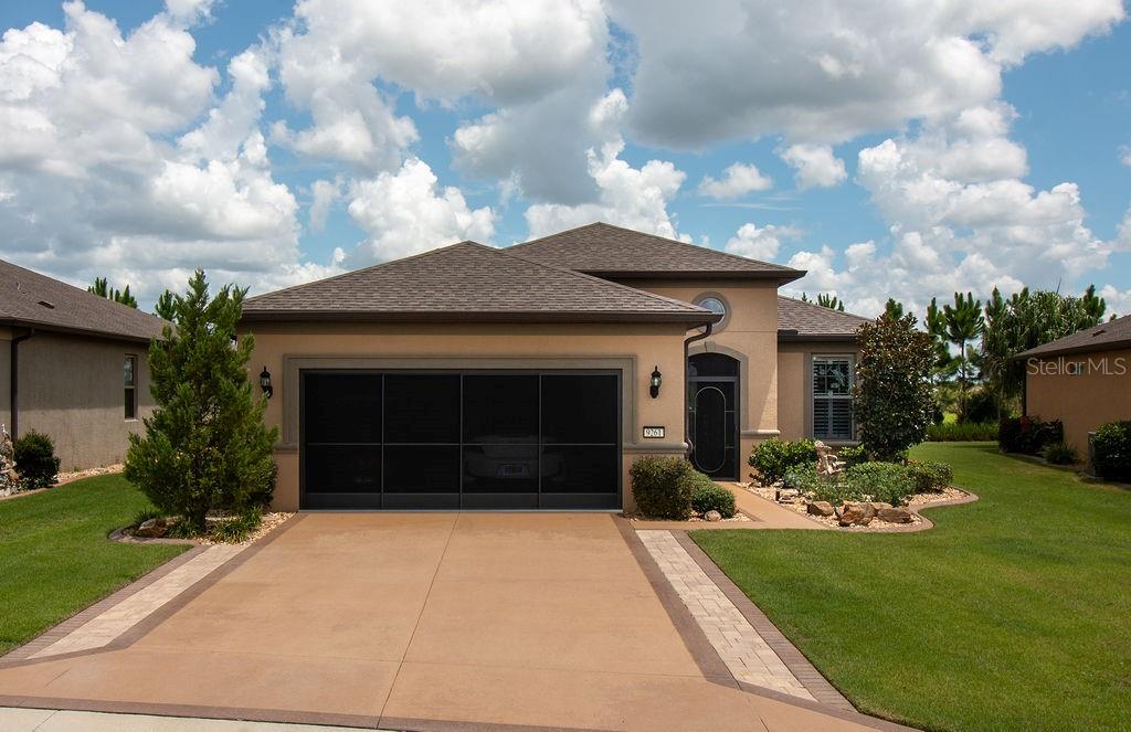 9261 Southwest 70th Loop Ocala, FL 34481 - Photo 1 of 1 a front view of a house with a garden and yard