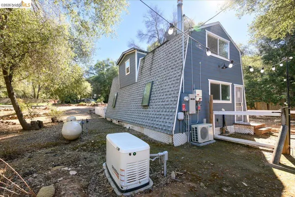 a view of a house with backyard and trees
