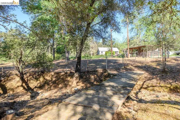 a view of a chairs and table in backyard