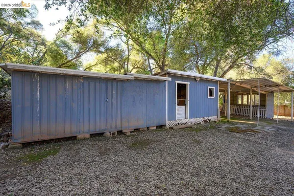 a view of a patio with table and chairs and potted plants