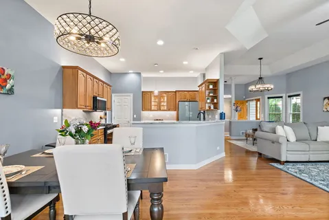 a living room with kitchen island furniture and a chandelier
