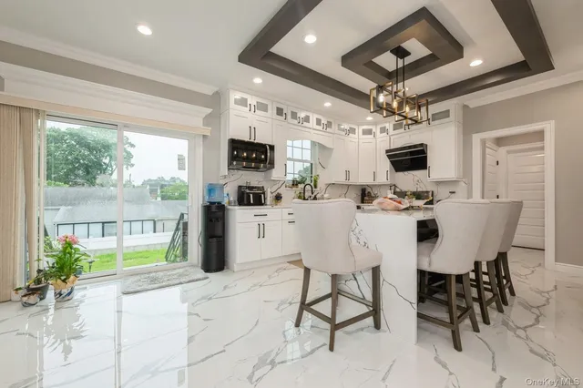 a dining room with furniture a chandelier and window