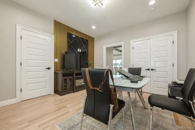 a view of a workspace with furniture and wooden floor