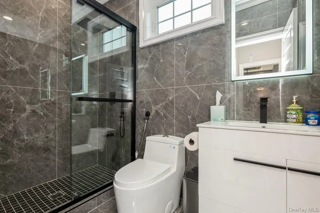 a bathroom with a toilet and a shower