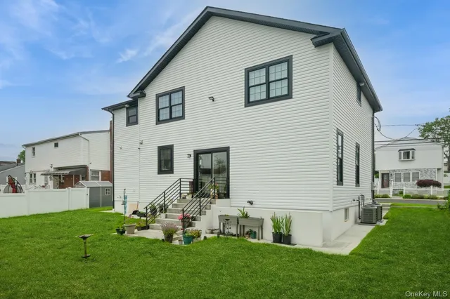 a front view of house with yard and outdoor seating