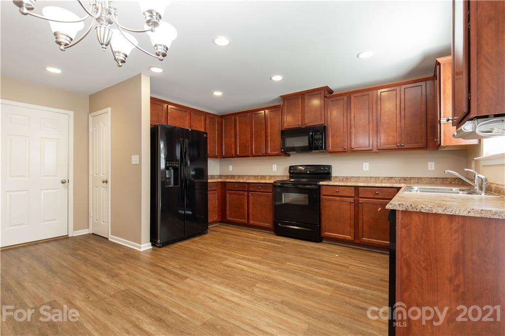 3002 Arthur Road Indian Land, SC 29707 - Photo 11 of 25 a kitchen with granite countertop stainless steel appliances and wooden cabinets