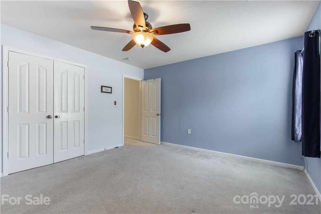 3002 Arthur Road Indian Land, SC 29707 - Photo 13 of 25 an empty room with closet and a chandelier fan