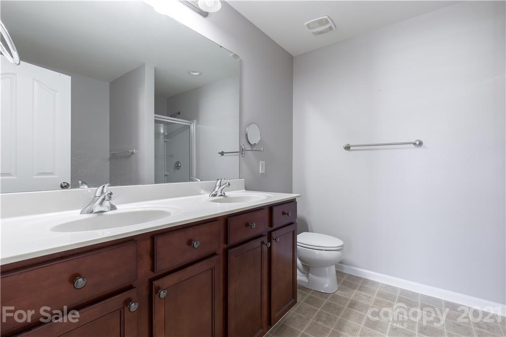 3002 Arthur Road Indian Land, SC 29707 - Photo 16 of 25 a bathroom with a double vanity sink toilet and a mirror